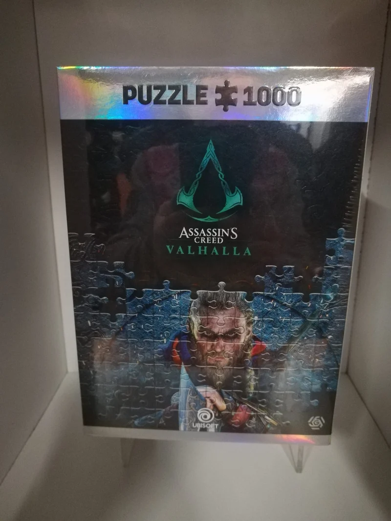 PUZZLE 1000 P.- ASSASSIN'S CREED VALHALLA +POSTER+BEG COTTONE
